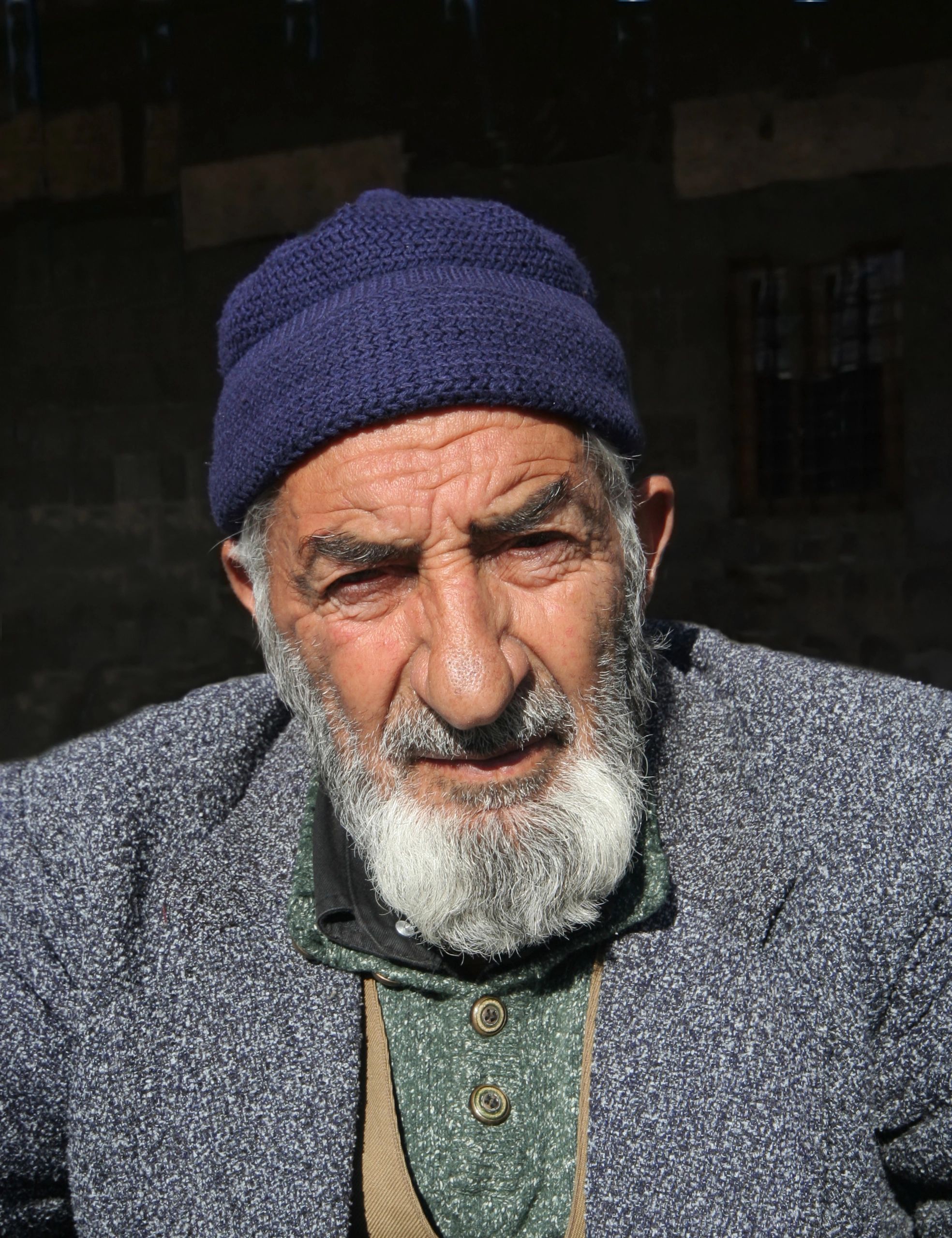 Older man seated outside a mosque in Diyarbakir